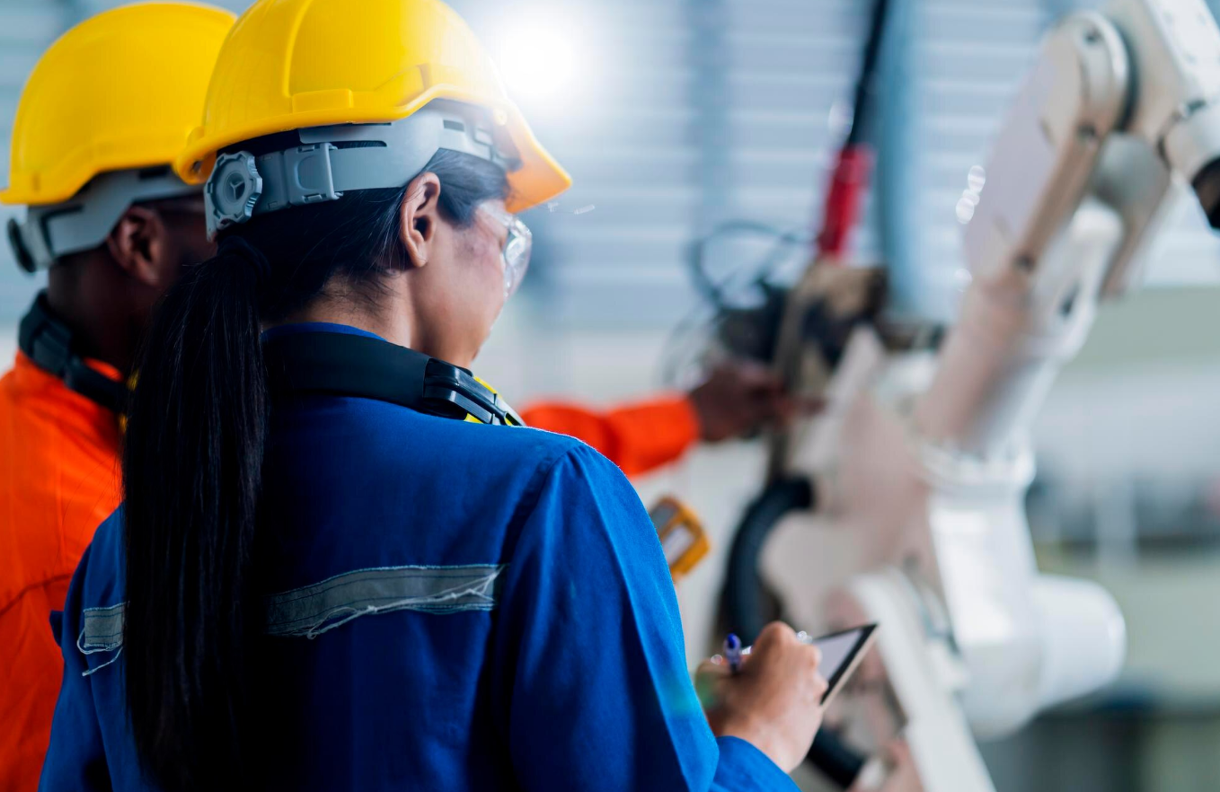A maintenance technician following step-by-step instructions from a work order to perform equipment repairs.