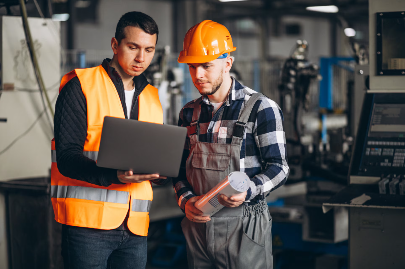 Technicians using a mobile device to access and update work orders on-site, improving maintenance efficiency.
